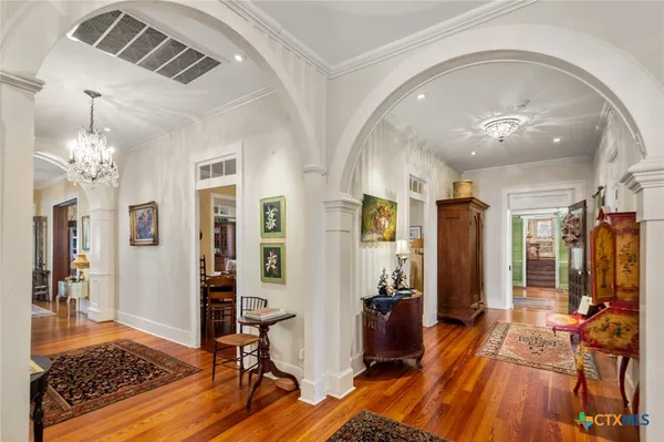 a view of a livingroom with hardwood floor and a ceiling fan
