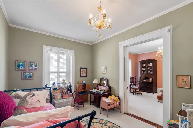 a living room with furniture and a chandelier