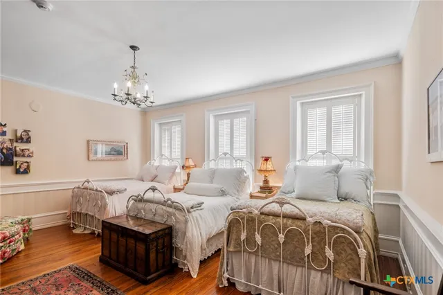 a bedroom with double bed and a chandelier