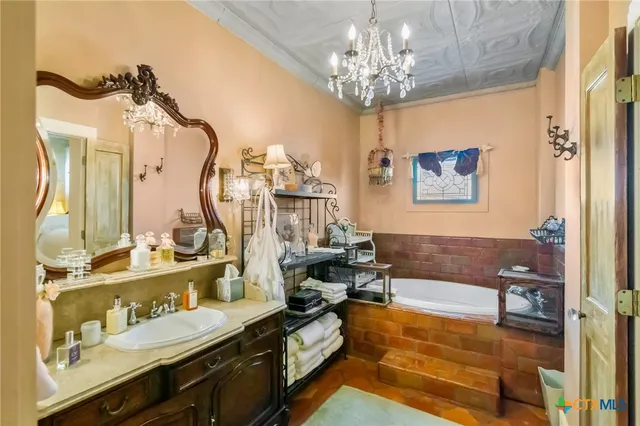 a living room with furniture chandelier and a chandelier