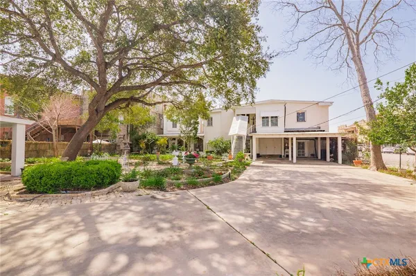 a view of house with outdoor space and trees