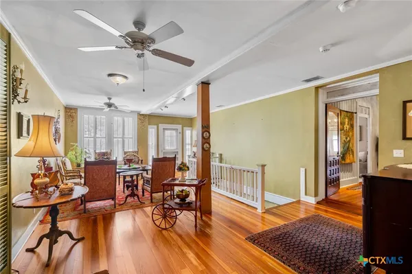 a living room with furniture and wooden floor
