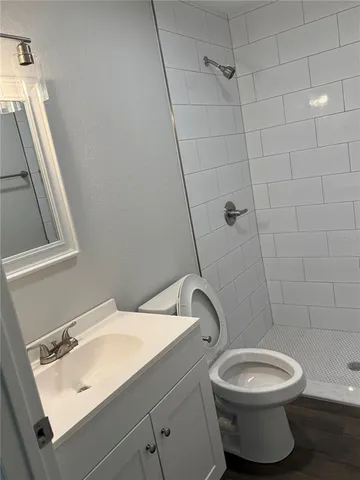 a bathroom with a sink toilet and shower