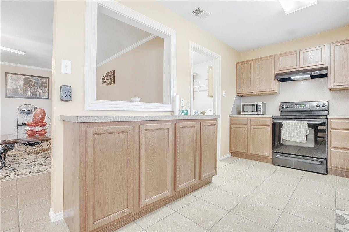 903 Xavier Street Lubbock, TX 79403 - Photo 16 of 28 a kitchen with white cabinets and white appliances