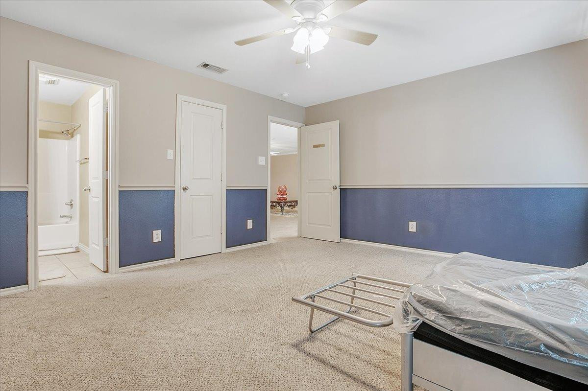 903 Xavier Street Lubbock, TX 79403 - Photo 20 of 28 a view of an empty room and chandelier fan