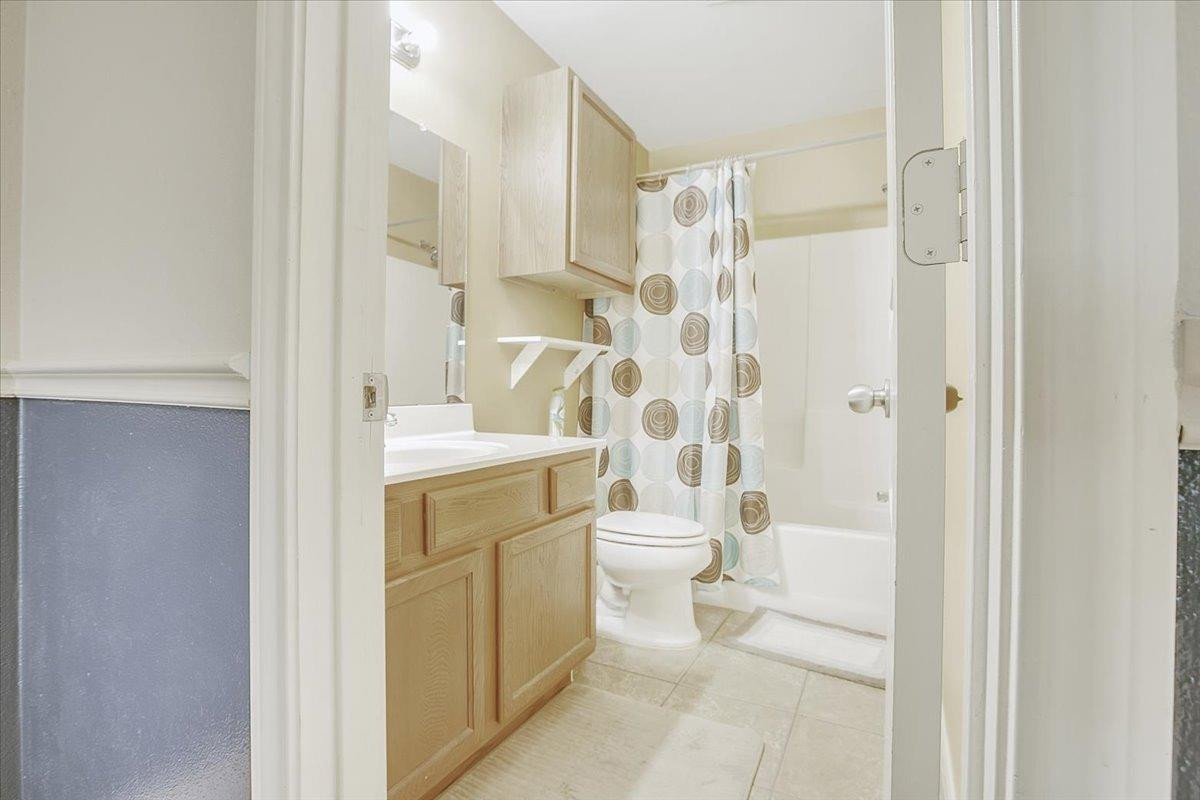 903 Xavier Street Lubbock, TX 79403 - Photo 22 of 28 a bathroom with a toilet sink and shower
