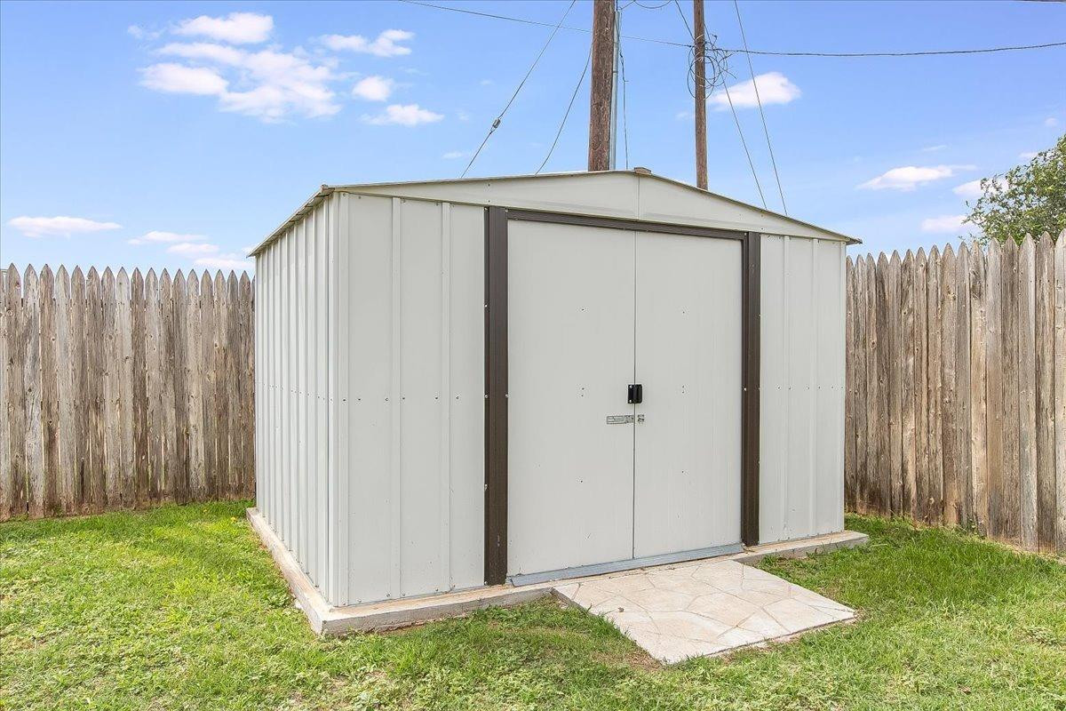 903 Xavier Street Lubbock, TX 79403 - Photo 24 of 28 a view of backyard with tub and trees in the background