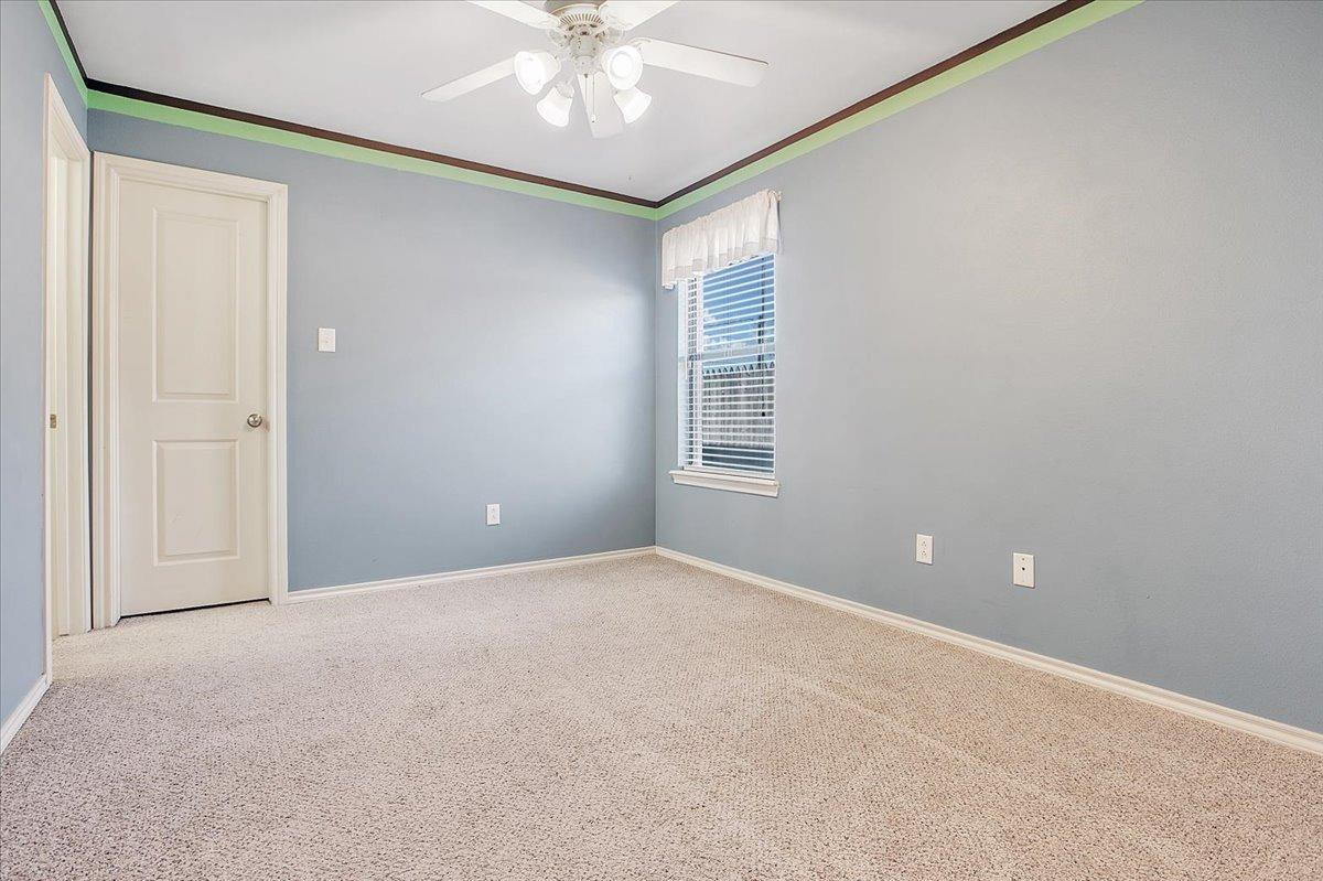 903 Xavier Street Lubbock, TX 79403 - Photo 6 of 28 a view of an empty room with a window