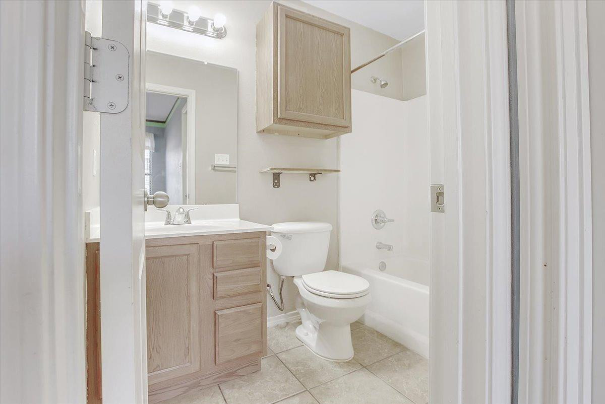 903 Xavier Street Lubbock, TX 79403 - Photo 8 of 28 a bathroom with a sink toilet and shower