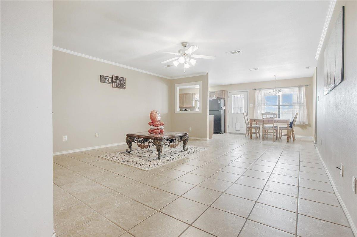 903 Xavier Street Lubbock, TX 79403 - Photo 10 of 28 a view of a dining room with furniture and chandelier