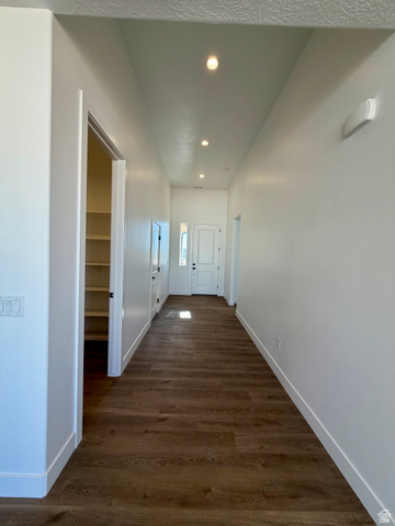 4956 North 925 East, Unit 87 Enoch, UT 84721 - Photo 4 of 19 Hallway featuring wood-finish flooring, recessed ceiling lighting, a built-in pantry with shelving, white baseboards, and a front entry door with sidelights