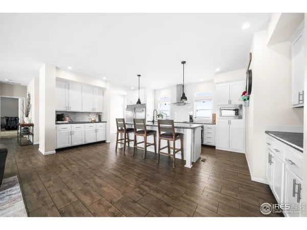 a kitchen with sink stove and cabinets