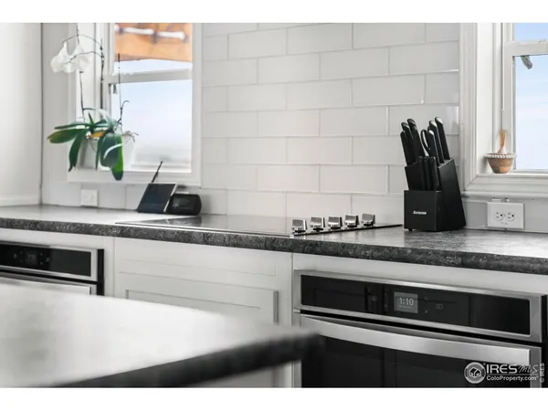 a kitchen with kitchen island a sink appliances and a counter top space