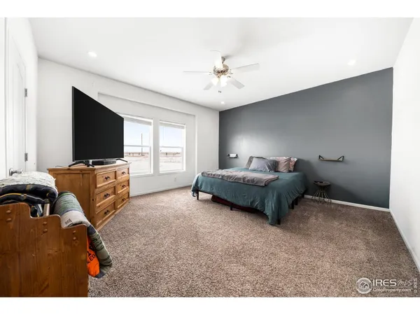 a spacious bedroom with a bed and a window