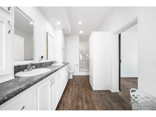 a spacious bathroom with a granite countertop tub sink and mirror