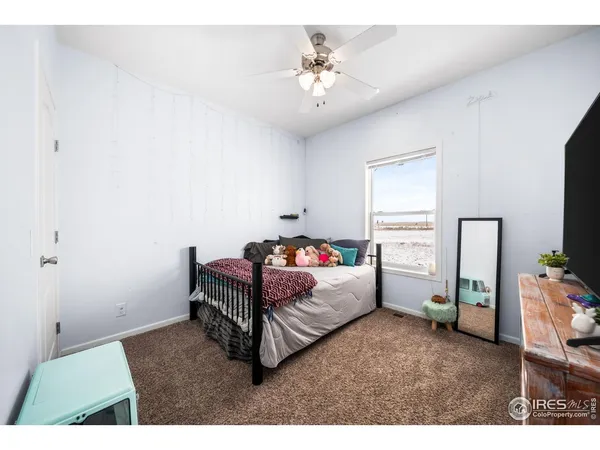 a kitchen with granite countertop a sink cabinets and wooden floor