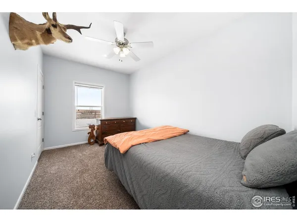 a bathroom with a granite countertop sink a toilet and a mirror