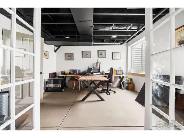 a living room with furniture a rug and a window