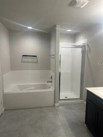 a bathroom with a bathtub and a shower