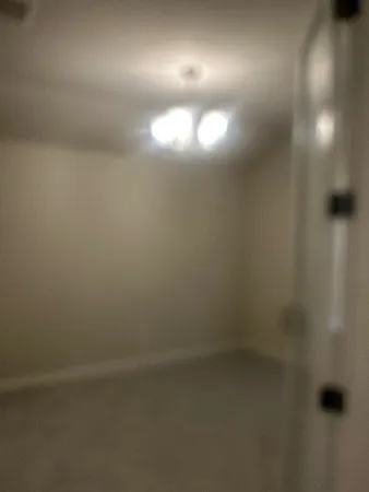 an empty room with a space and windows