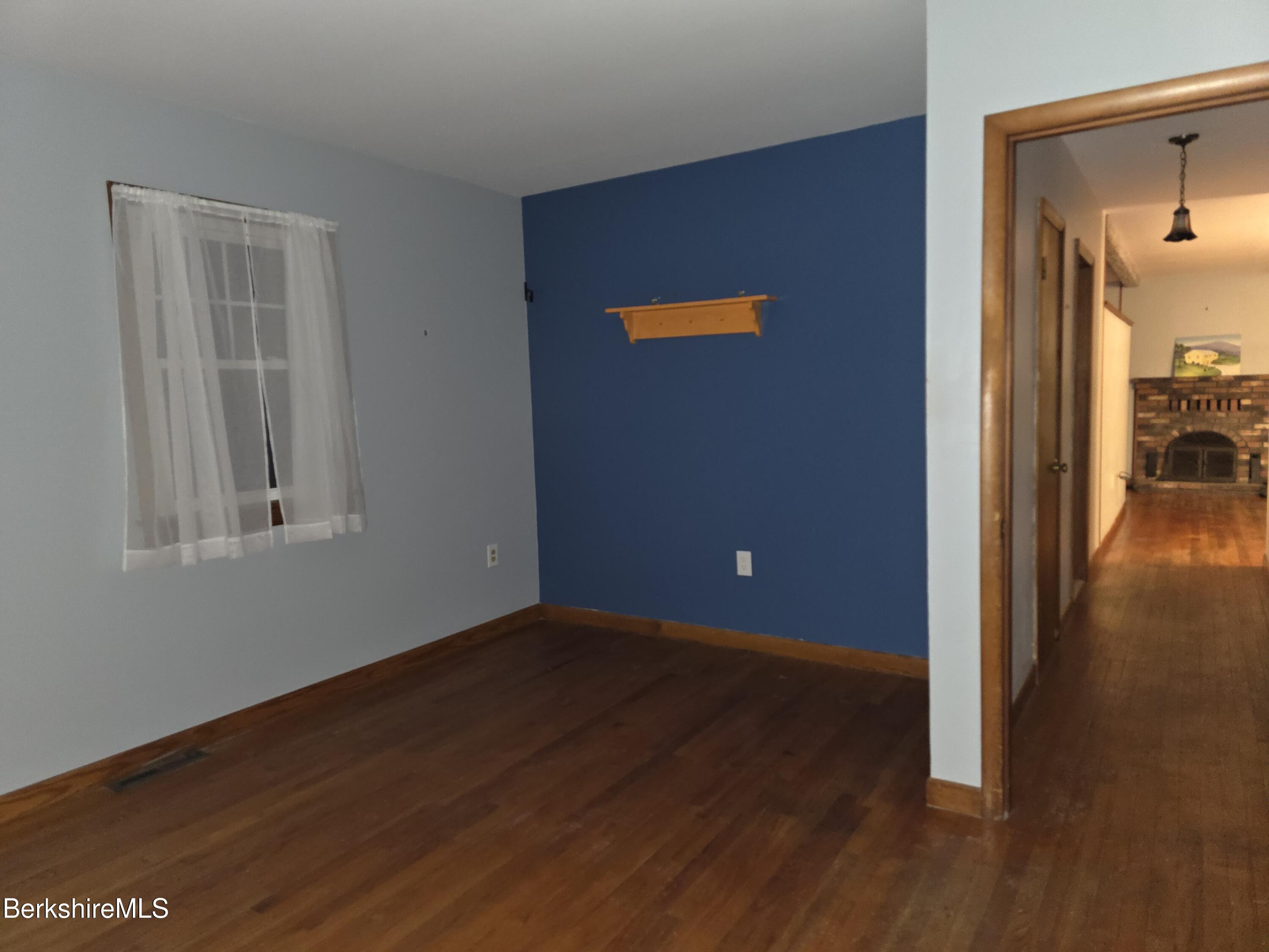 15 W Road Adams, MA 01220 - Photo 26 of 37 a view of a livingroom with wooden floor and a hallway