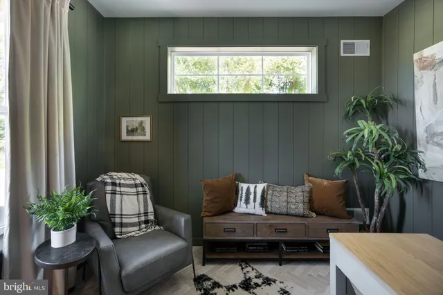 a living room with furniture and a potted plant
