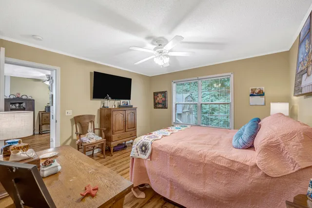 a bedroom with a bed window and a flat screen tv