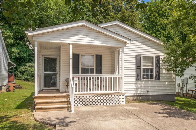 a front view of a house with a small yard