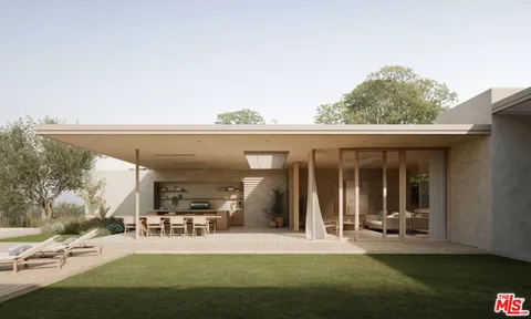 a view of a patio with table and chairs potted plants and floor to ceiling window