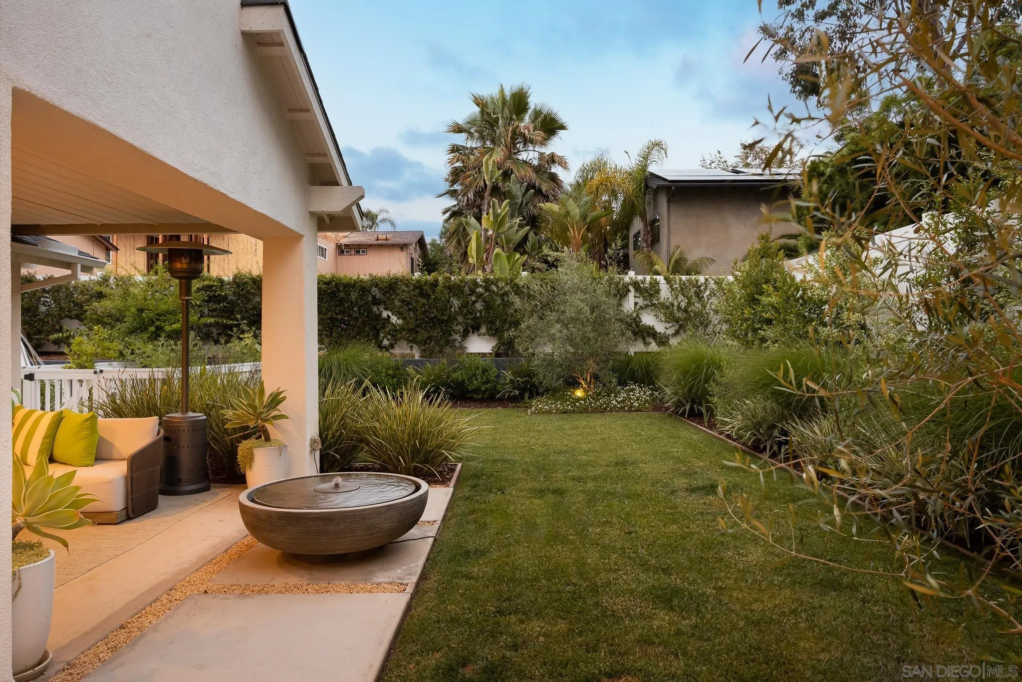 775 Normandy Road Encinitas, CA 92024 - Photo 26 of 44 a view of a patio with table and chairs potted plants with wooden floor