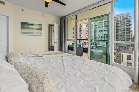 a bedroom with a bed and a large window