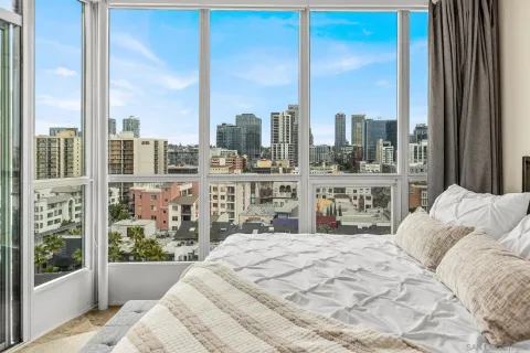 a bedroom with a large bed and a large window