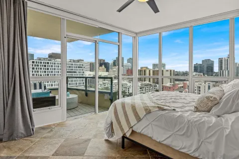 a bedroom with a bed and glass window