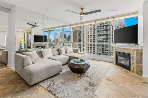 a living room with furniture a flat screen tv and a fireplace