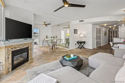 a living room with furniture a flat screen tv and a fireplace