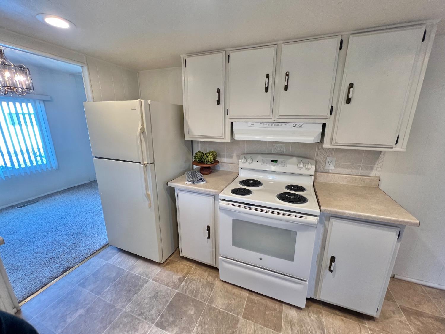 3955 Coffee Road, Unit 53 Modesto, CA 95355 - Photo 23 of 39 a kitchen with white cabinets and white appliances