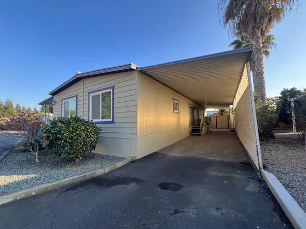 a view of a house with a backyard