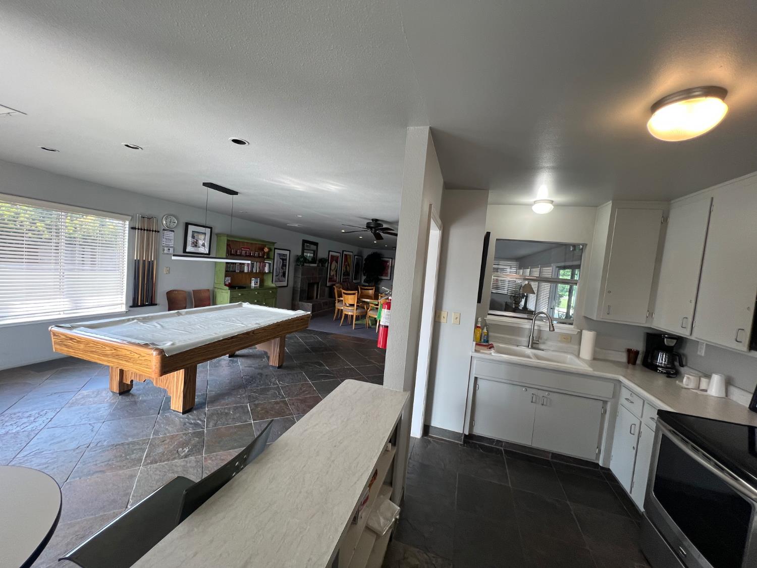 3955 Coffee Road, Unit 53 Modesto, CA 95355 - Photo 39 of 39 a kitchen view with stainless steel appliances kitchen island hardwood floor and a sink
