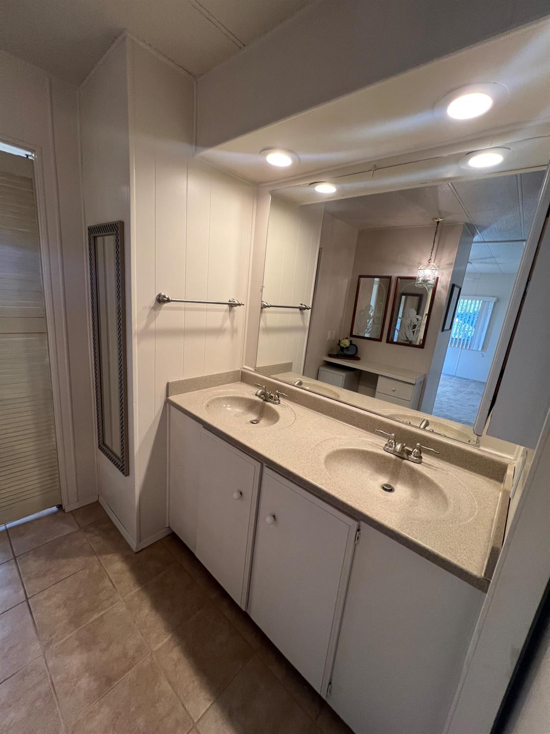 3955 Coffee Road, Unit 53 Modesto, CA 95355 - Photo 10 of 39 a bathroom with a double vanity sink and mirror