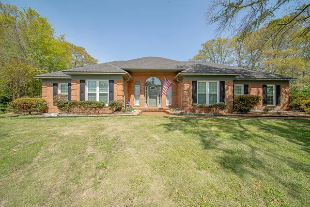 a front view of a house with garden