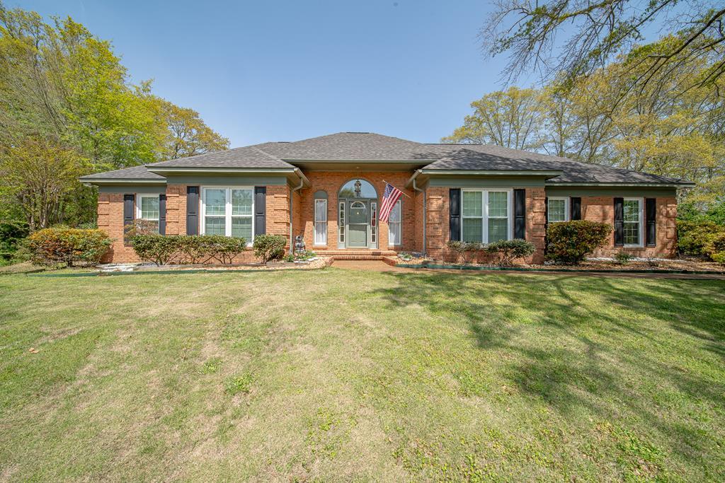 a front view of a house with garden