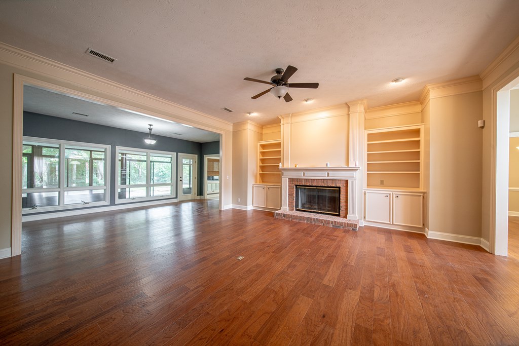 5 Mink Court Midland, GA 31820 - Photo 12 of 42 a view of an empty room with wooden floor and a fireplace