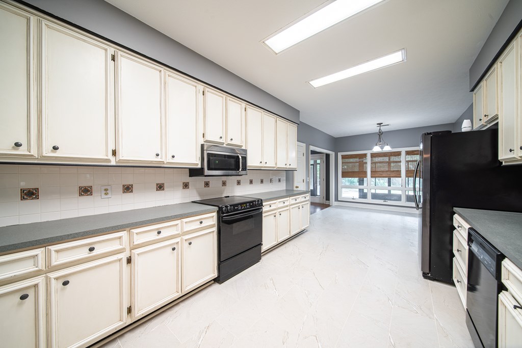 5 Mink Court Midland, GA 31820 - Photo 15 of 42 a kitchen with stainless steel appliances granite countertop a refrigerator a sink dishwasher a stove and white cabinets