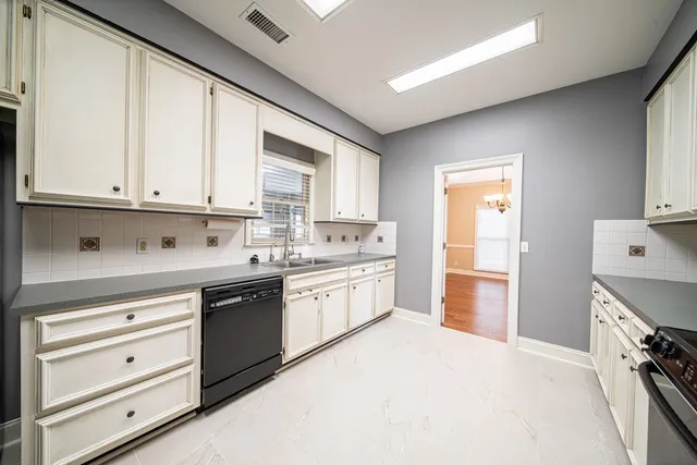 a kitchen with stainless steel appliances granite countertop a stove and a refrigerator