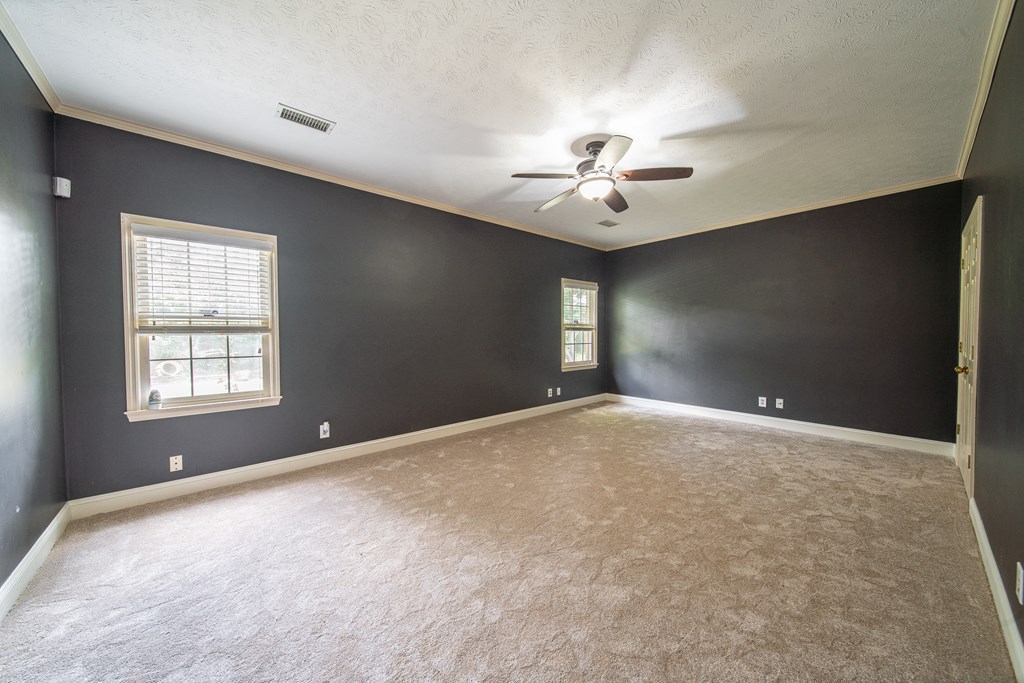 5 Mink Court Midland, GA 31820 - Photo 22 of 42 en empty room with windows and chandelier fan