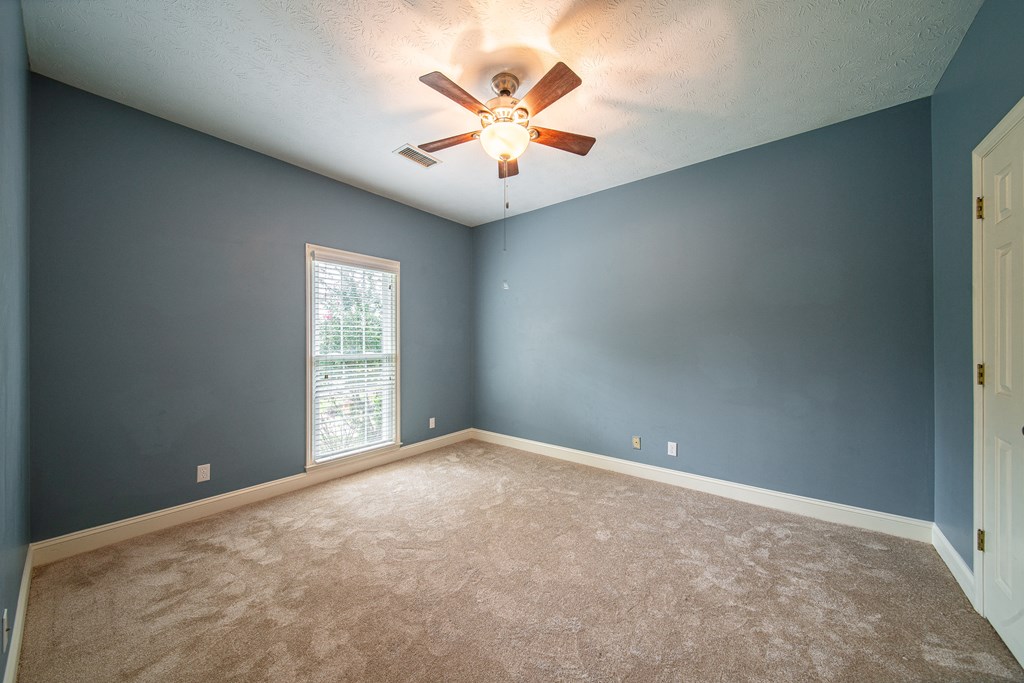 5 Mink Court Midland, GA 31820 - Photo 24 of 42 an empty room with ceiling fan and window