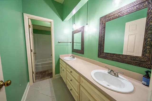 a bathroom with a double vanity sink and a mirror
