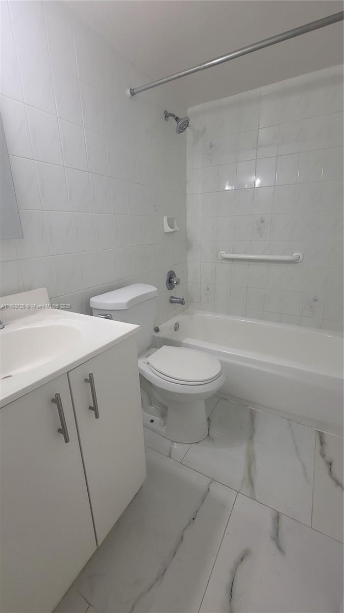 5201 Northwest 7th Street, Unit 106 Miami, FL 33126 - Photo 11 of 20 a bathroom with a sink a toilet and shower