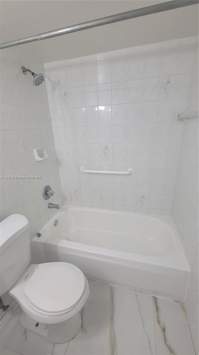 5201 Northwest 7th Street, Unit 106 Miami, FL 33126 - Photo 12 of 20 a bathroom with a toilet and a shower