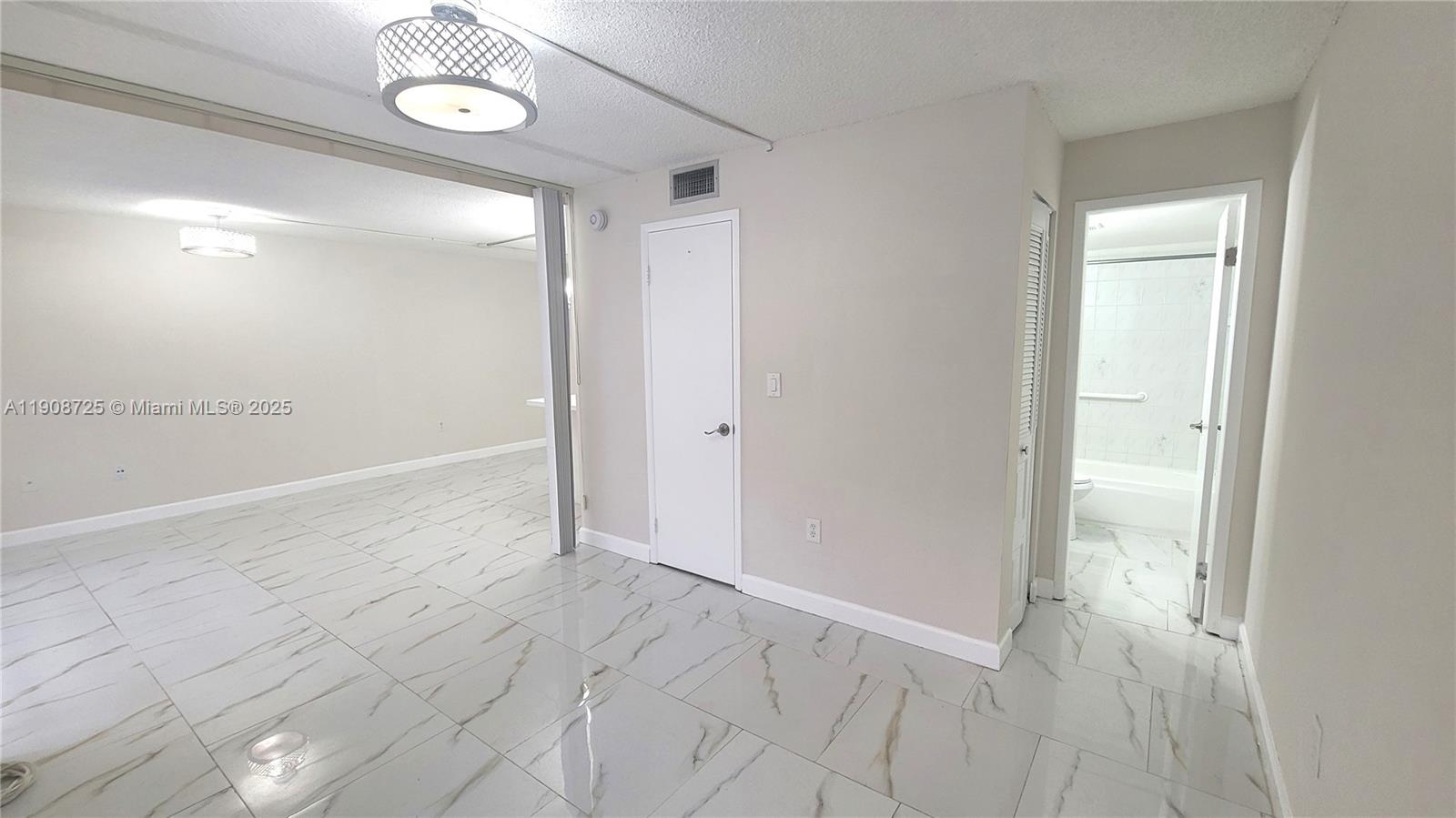 5201 Northwest 7th Street, Unit 106 Miami, FL 33126 - Photo 15 of 20 an empty room with wooden floor and windows